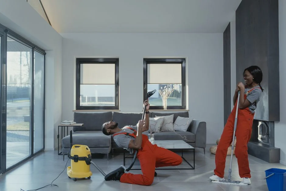 Individual in protective gear standing in a contemporary kitchen setting during the day.